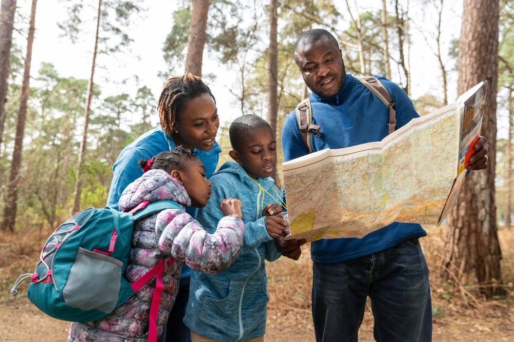 family traveling together through woods